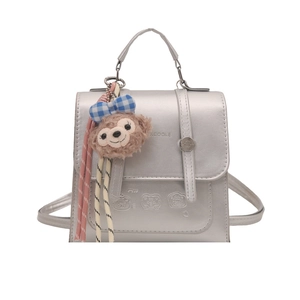 Metallic silver backpack with XCOOLE branding and a plush bear charm on white background