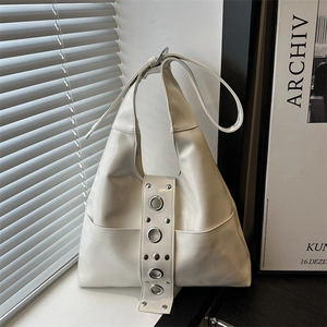 Chic cream white faux leather hobo bag with silver eyelets and rivets on wide strap