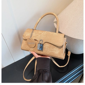 Detail of khaki crossbody bag with wave edge flap and polished silver square lock