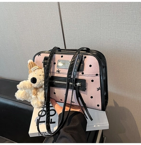 Pink canvas handbag with black polka dots, bow print and cute plush bear accessory
