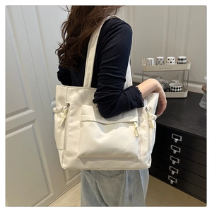 Off-white large capacity tote bag with side drawstring pockets and zip front pocket