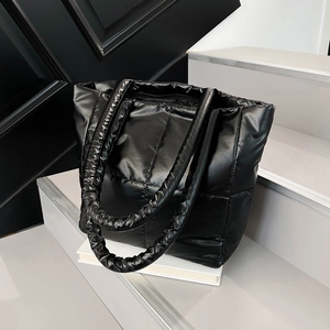 Chic black quilted puffer tote bag with glossy finish and thick padded straps for women