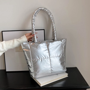 Chic silver metallic quilted tote bag with padded handles for fashionable autumn style