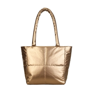 Modern gold metallic quilted puffer tote bag with padded handles and luxury finish