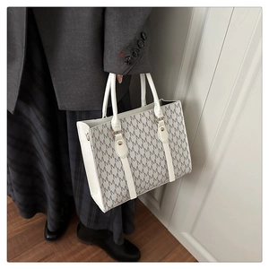 Detail view of large capacity tote bag with grey and white M-letter logo pattern