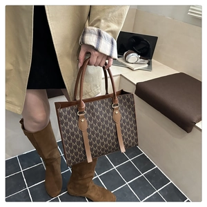 Chic brown tote bag with M-pattern print and leather handles for daily commuting