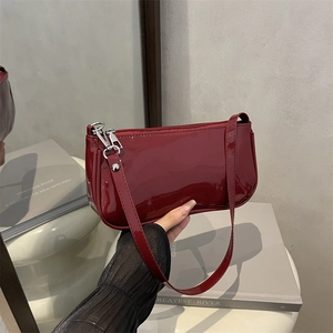 Glossy red patent leather underarm baguette bag with silver hardware for women