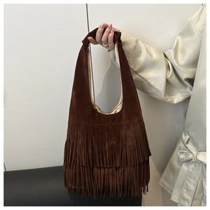 Detailed view of dark brown suede handbag featuring double-layered stylish fringes