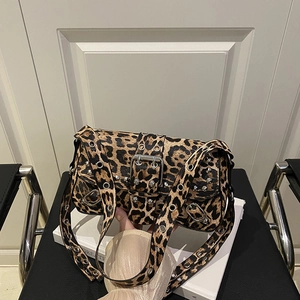 Y2K leopard print shoulder bag with silver studs and metal eyelets on a black chair