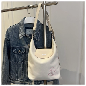 Detail of cream white tote bag with cute dog embroidery and metallic bone buckle