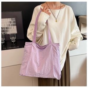 Close-up of a large lavender tote bag with wide shoulder straps for daily commuting