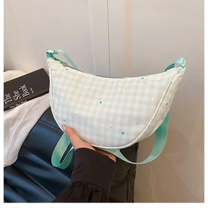 Detail showing mint green checkered canvas moon bag with colorful star embroidery and zipper