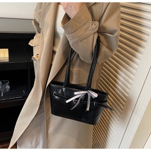 Sac fourre-tout classique en cuir noir avec ruban rose décoratif sur de longues bandoulières