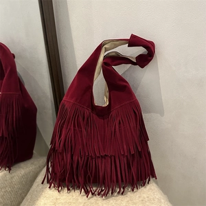 Vintage burgundy suede tote bag with boho tassels and knotted shoulder strap