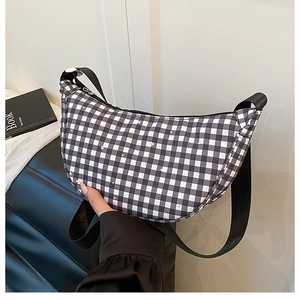 Detail of checkered crescent bag with star prints and adjustable black nylon strap