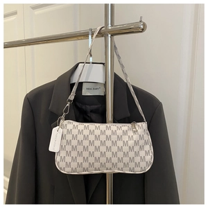 Detailed shot of white shoulder bag with grey M-letter monogram and silver metal zipper