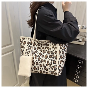 Detail of leopard print tote bag with a small matching cream pouch and shoulder strap