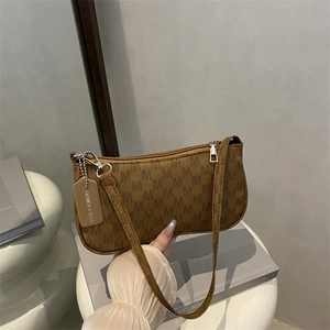 Brown baguette shoulder bag with all-over M letter print and silver zipper detail