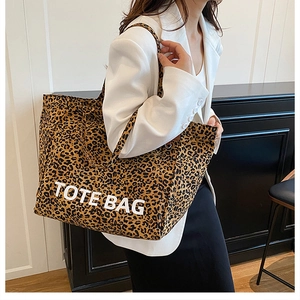 Detail of leopard print canvas tote bag with large white TOTE BAG text print