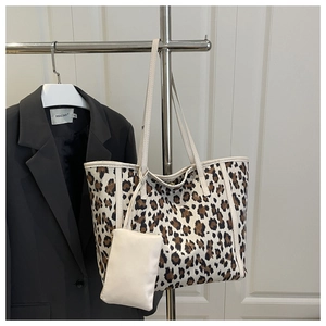 Dettaglio della borsa tote leopardata con una piccola custodia bianca staccabile