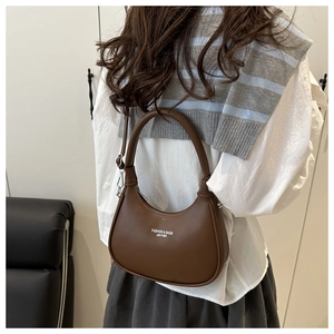 Close-up of brown leather hobo bag with Fashion & Bags text and silver zipper detail