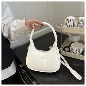 Detail of off-white dumpling bag with FASHION & BAGS LEATHER print and round handle
