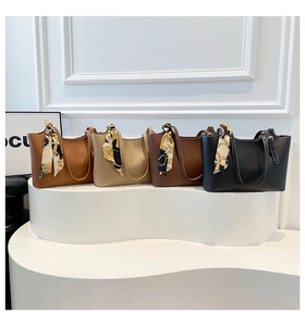 Detailed view of four retro bucket tote bags with silk ribbon handles in earthy tones