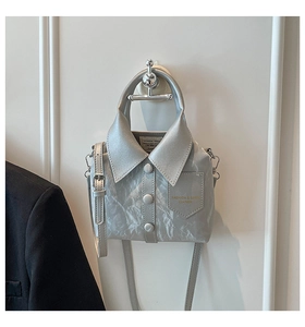 Detail view of silver shirt-shaped bucket bag with realistic collar and button accents