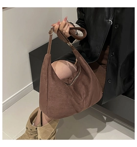 Brown suede hobo shoulder bag styled with leather jacket for trendy autumn fashion look
