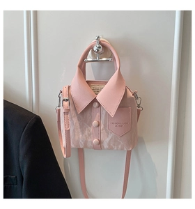 Detail of pink shirt-style handbag with lapel design, buttons, and marble texture PU leather