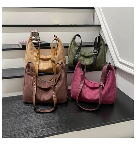 Detail view of suede tote bags in khaki, olive, brown, and wine red with adjustable straps