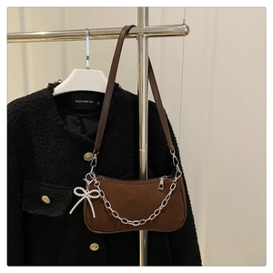 Detail of matte brown hobo bag with silver chunky chain and pearl bow charm