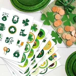 St. Patrick's Day clover stickers set with green shamrocks and gold coins on wood