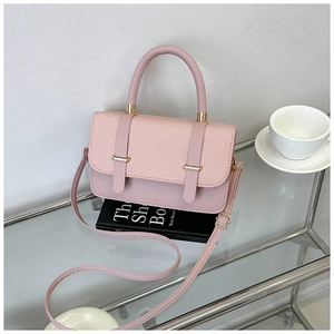 Detailed top view of pink messenger bag with woven texture and gold metal hardware