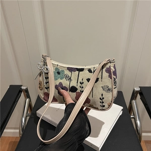 Floral print crescent shoulder bag in cream woven fabric with pearl bow charm detail