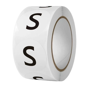 Roll of round white adhesive size stickers with black letter S for clothing and hats