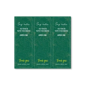 Detail view of dark green waterproof stickers with gold foil floral patterns and THANK YOU text