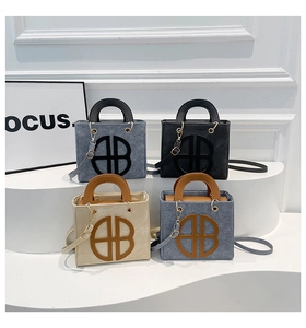 Detailed view of tote bags with B logo in denim blue, black, and beige textures
