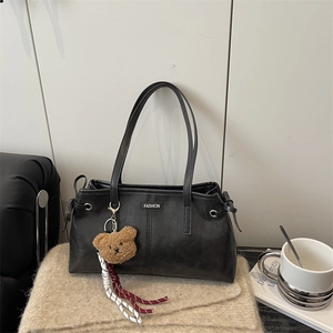 Black leather shoulder bag with double straps, fashion metal tag, and cute bear charm