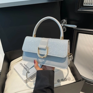 Minimalist light blue leather crossbody bag with silver glitter flap and gold D-clasp
