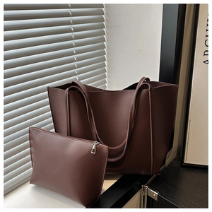 Detail of vintage brown tote bag set with matching zipper pouch and leather texture