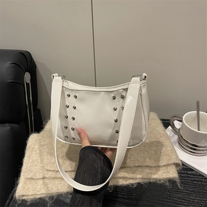 White minimalist underarm bag with silver rivets and vintage smooth leather finish