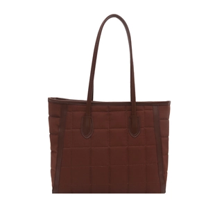 Deep brown quilted tote bag with stitched grid pattern and leather-style handles