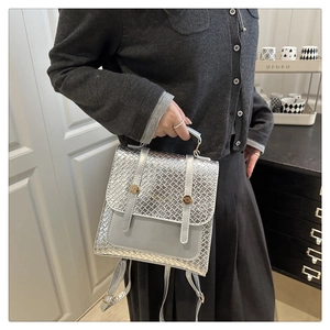 Silver woven texture backpack featuring gold hardware and a versatile handle for women
