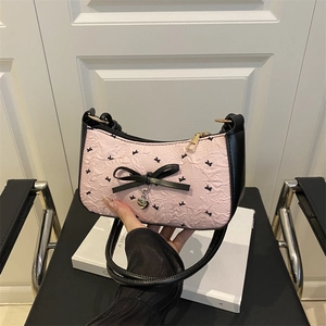 Pink seersucker bow shoulder bag with black animal prints and heart pendant charm