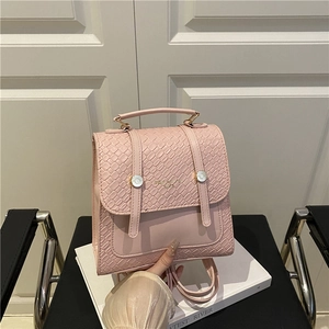 Pink British retro backpack with textured faux snake skin and gold buckle detail