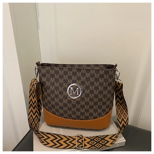Detail of a brown bucket bag with monogram print and geometric wide shoulder strap