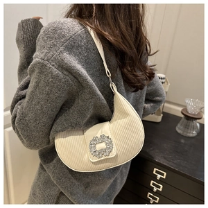 Détail du sac hobo plissé blanc cassé avec une boucle étincelante sertie de strass