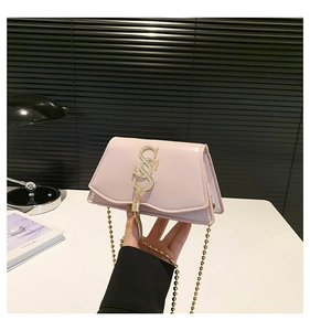 Pink glossy mini crossbody bag featuring golden letter logo and metallic tassel detail