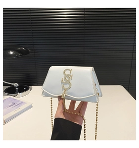 Detail of white PU leather mini bag with gold S-shaped buckle and fine bead chain